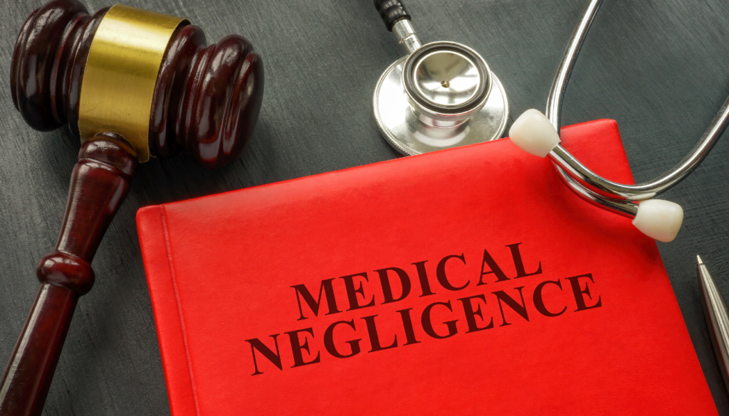a folder with the words medical negligence with a gavel and a stethoscope