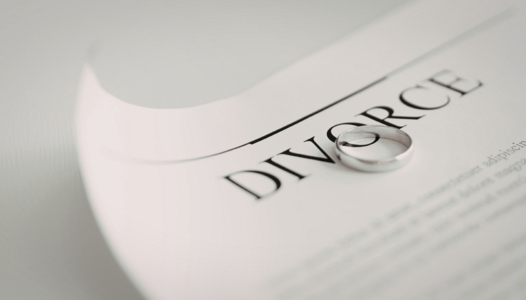 a paper with the word divorce and a wedding band