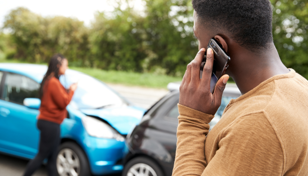 a man on phone calling a lawyer after car accident